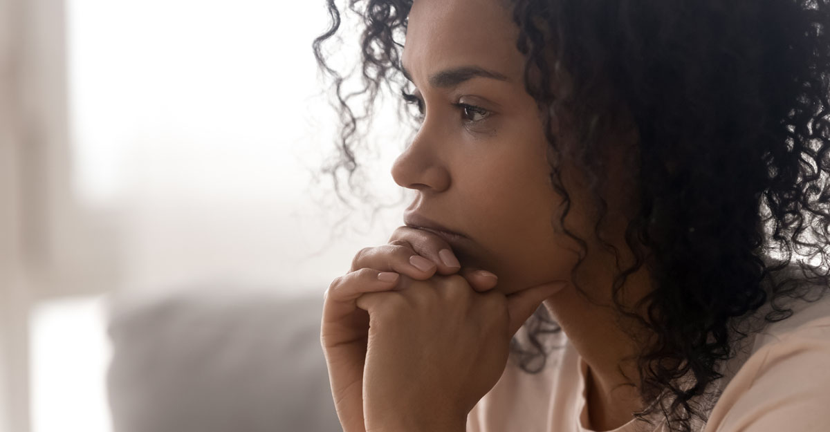 a woman staring into space, looking sad