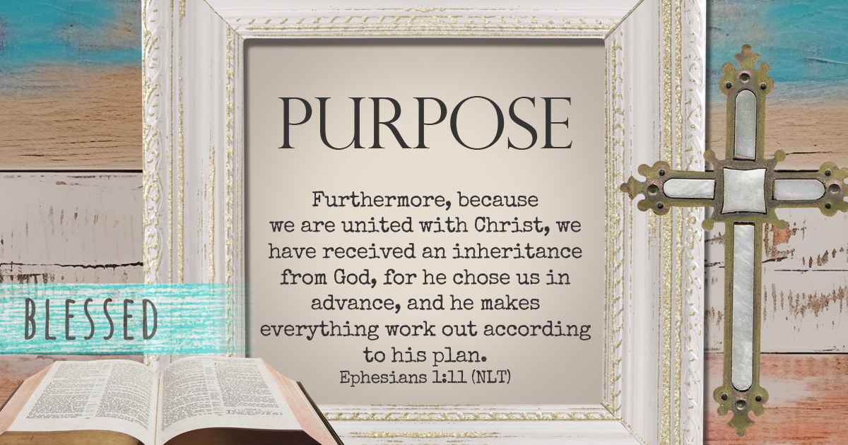 background of multicolored old wood with a cross, open bible, and the words of Ephesians 1:11.