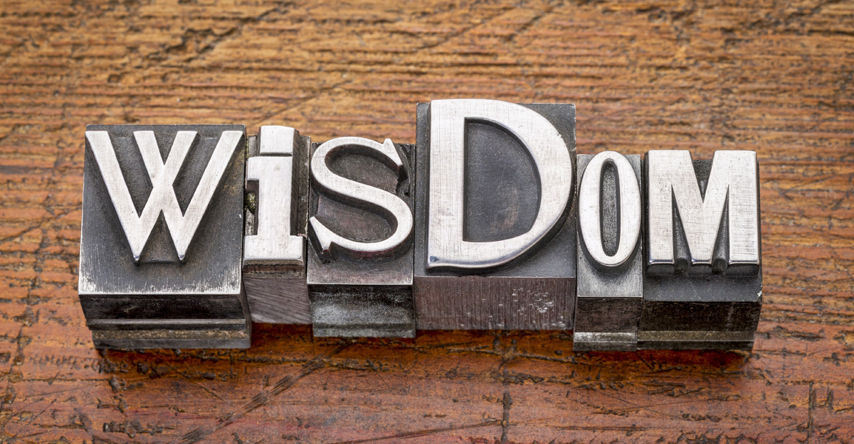 Wood background with the word wisdom written across