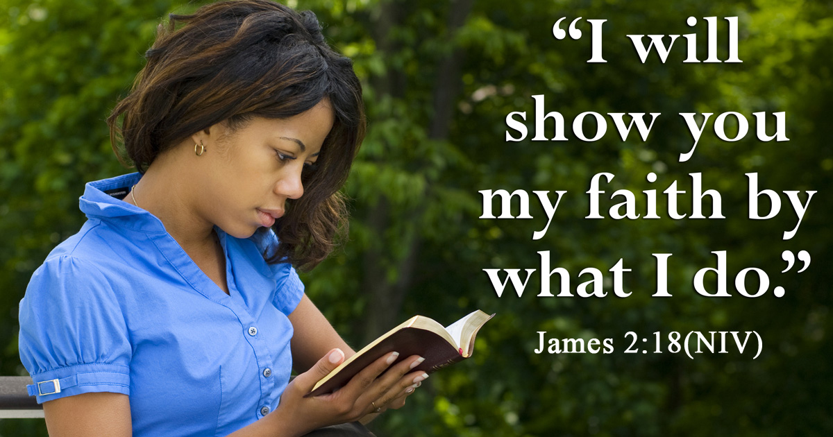 Beautiful young woman in the park reading the bible. John 2:18 NIV in the foreground.