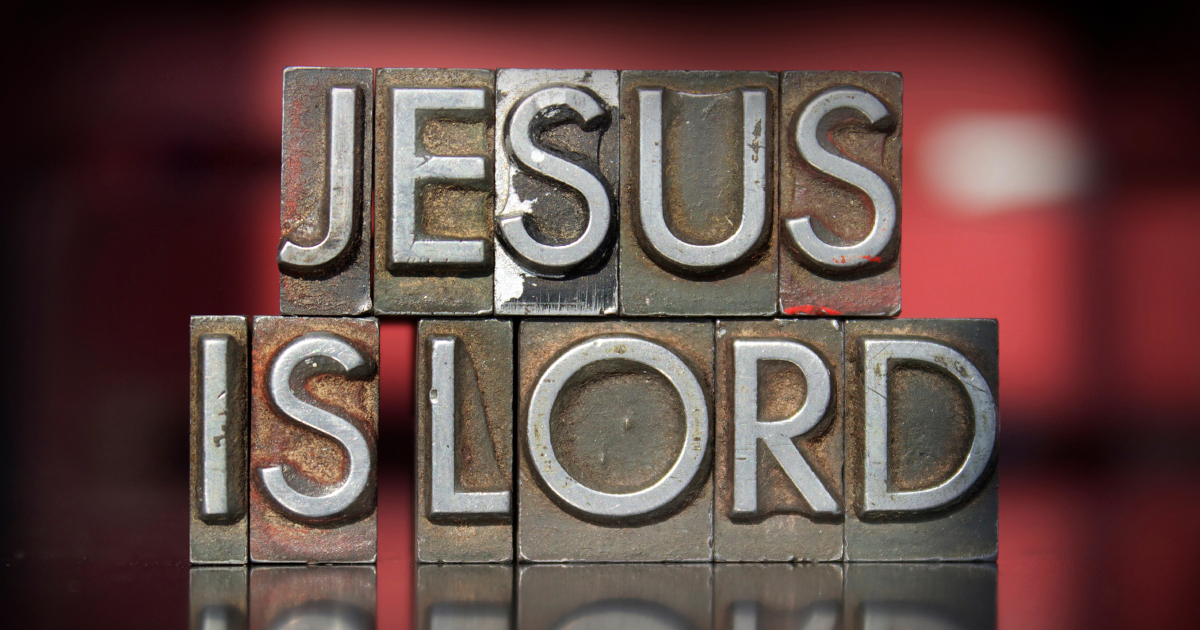 hues of red background with medal words that say Jesus is Lord