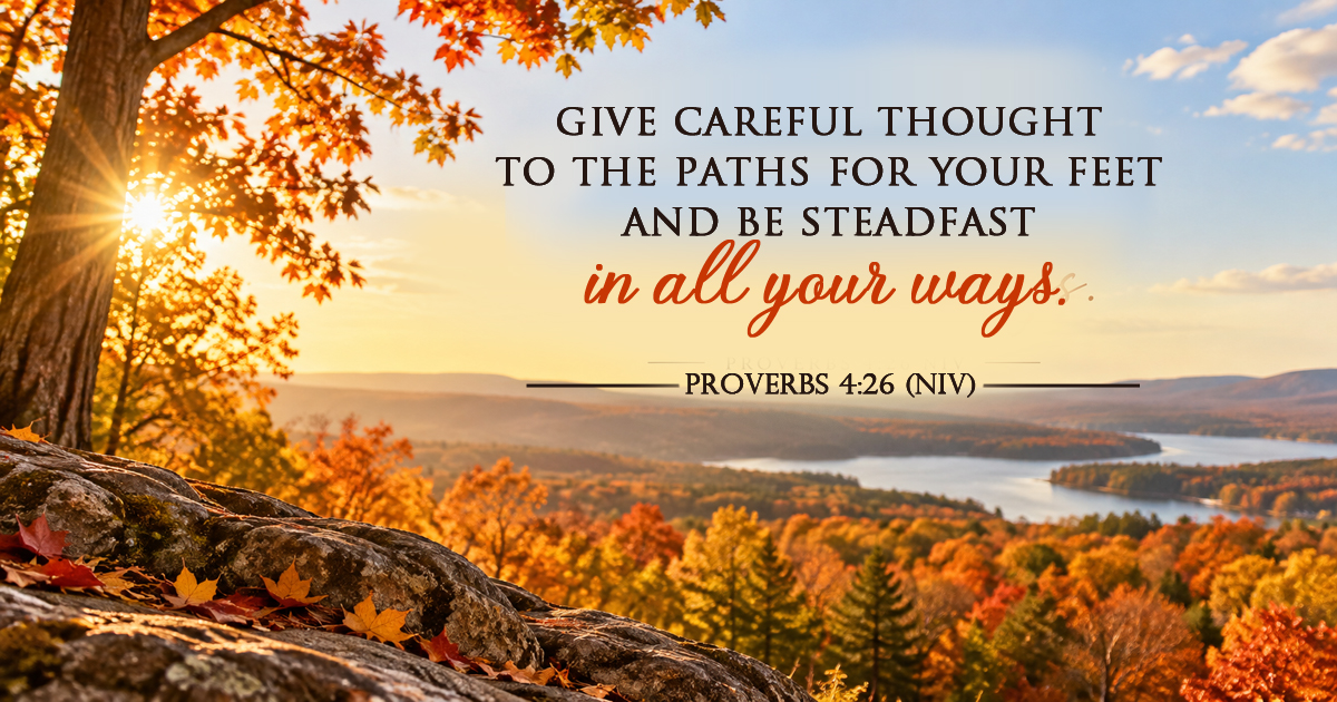 A peaceful autumn landscape on a bright sunny day, overlooking colorful fall trees, distant hills, and a winding lake, featuring Proverbs 4:26 NIV.